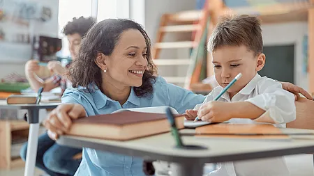 Teacher working with young student